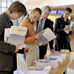 Conference visitors looking at brochures