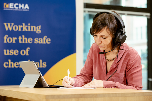 Woman with headset working with laptop